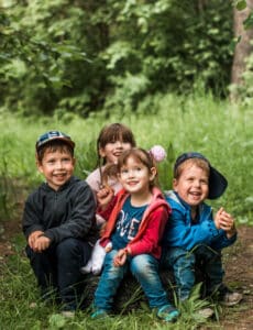 happy children sit on ground