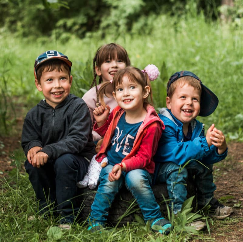 happy children sit on ground