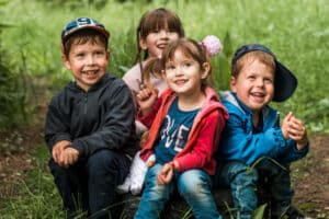 happy children sit on ground